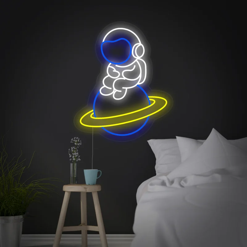 Astronaut Spaceman Sitting On Planet Neon Sign